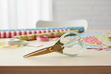 Load image into Gallery viewer, Scissors with gold blades and green handles on a white background