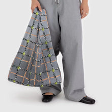 Load image into Gallery viewer, a person holding a baggu brand reusable bag in a gray color with balck and green jewels motif