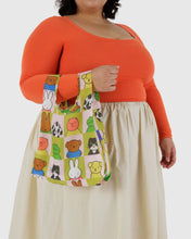 Load image into Gallery viewer, a person holding a baggu brand reusable bag with the miffy motif