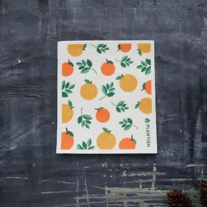a kitchen dishcloth with motif of oranges and leaves 