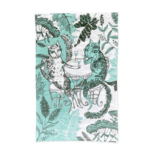 Load image into Gallery viewer, a tea towel with two cats sitting high in a tree having what appears to be a chat over wine 
