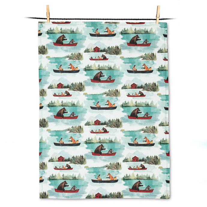 a tea towel with illustration of bears, foxes, racoons and rabbits in a canoe on a lake, very cottage 