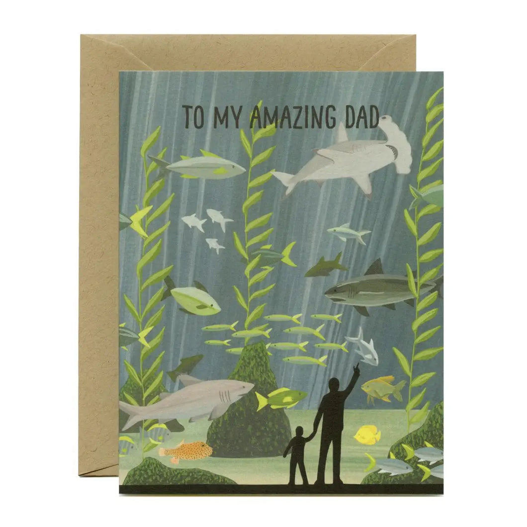 a greeting card with illustration of a man and child looking into a very large aquarium with fish and sharks swimming around. text to my amazing dad