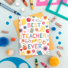 Load image into Gallery viewer, a colourful greeting card with illustrations of things teachers use, paper clips, apple, notepad, note book eyeglasses with text best teacher ever 
