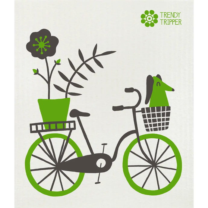 a Swedish dishcloth with an image of a green bike and a dog riding in the the basket with a big plower pot on the back 