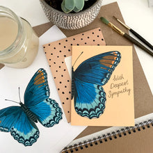 Load image into Gallery viewer, a greeting card on a desk with a blue butterfly and text. with deepest sympathy