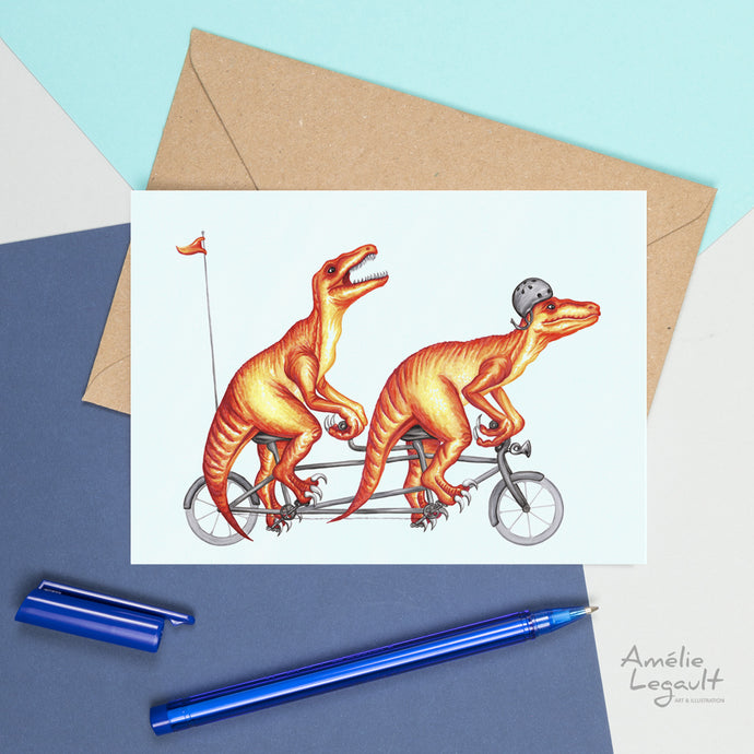 a greeting card with 2 dinosauras riding a bicycle built for 2