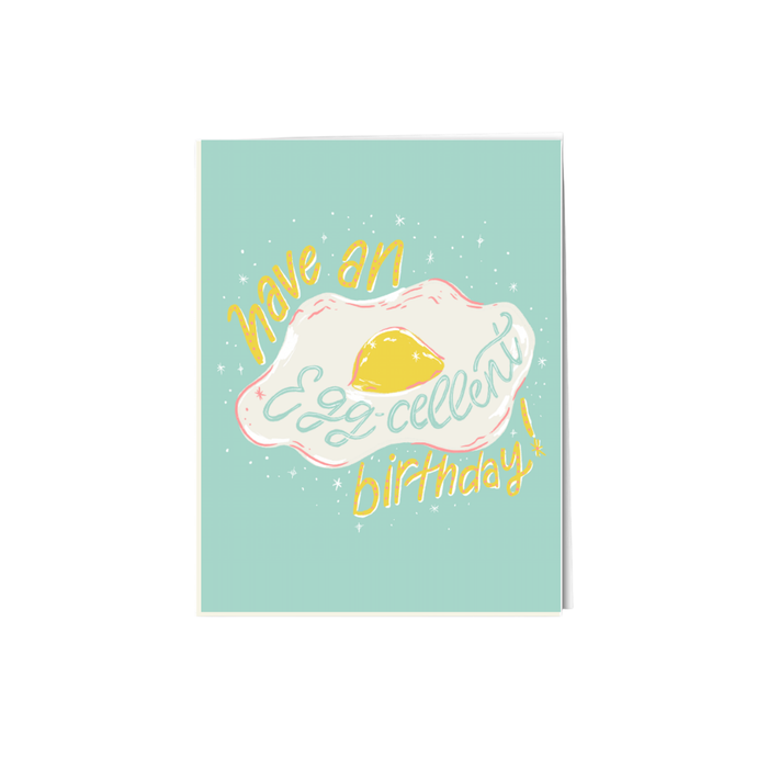 an illustration of a fried egg script says have an egg cellent birthday on a light green backdrop