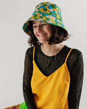 Load image into Gallery viewer, a person wearing a baggu brand buck hat in a retro 70&#39;s flower motif 
