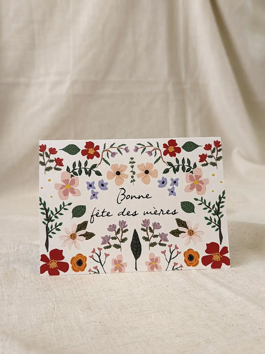 a greeting card with small painted flowers text bonne fete des meres 