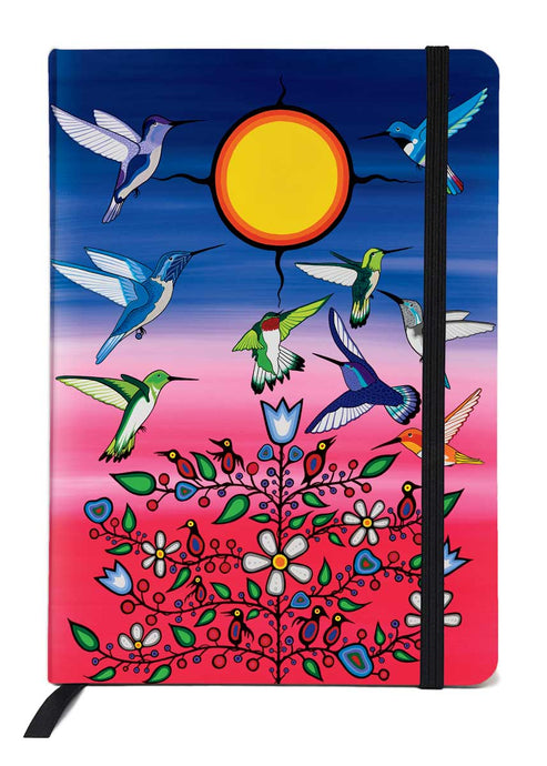 a brightly coloured journal in dark pink and dark blue with pictures of multi coloured hummingbirds, flowers and a bright yellow sun designed by an Indigenous artist 