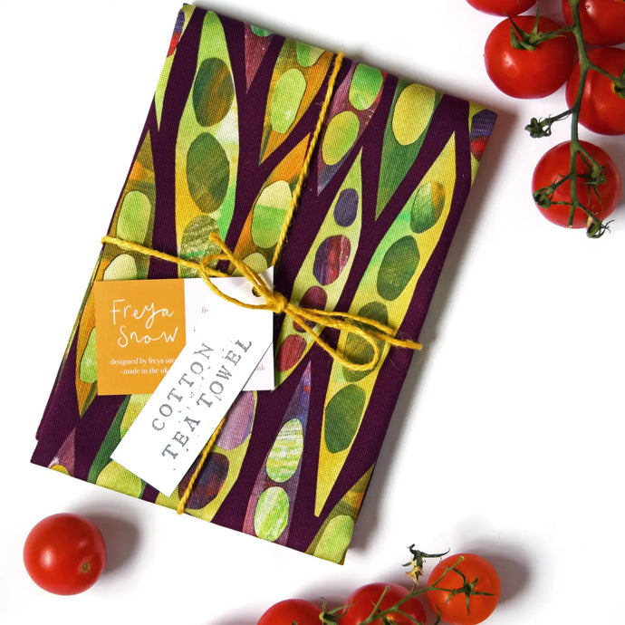a tea towel with colourful runner bean vegetables on it 