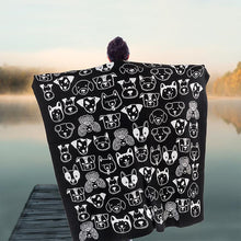 Load image into Gallery viewer, a person holding open a blanket throw with black and white dog faces on it 
