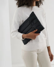 Load image into Gallery viewer, a person holding a black puffy laptop case by baggu
