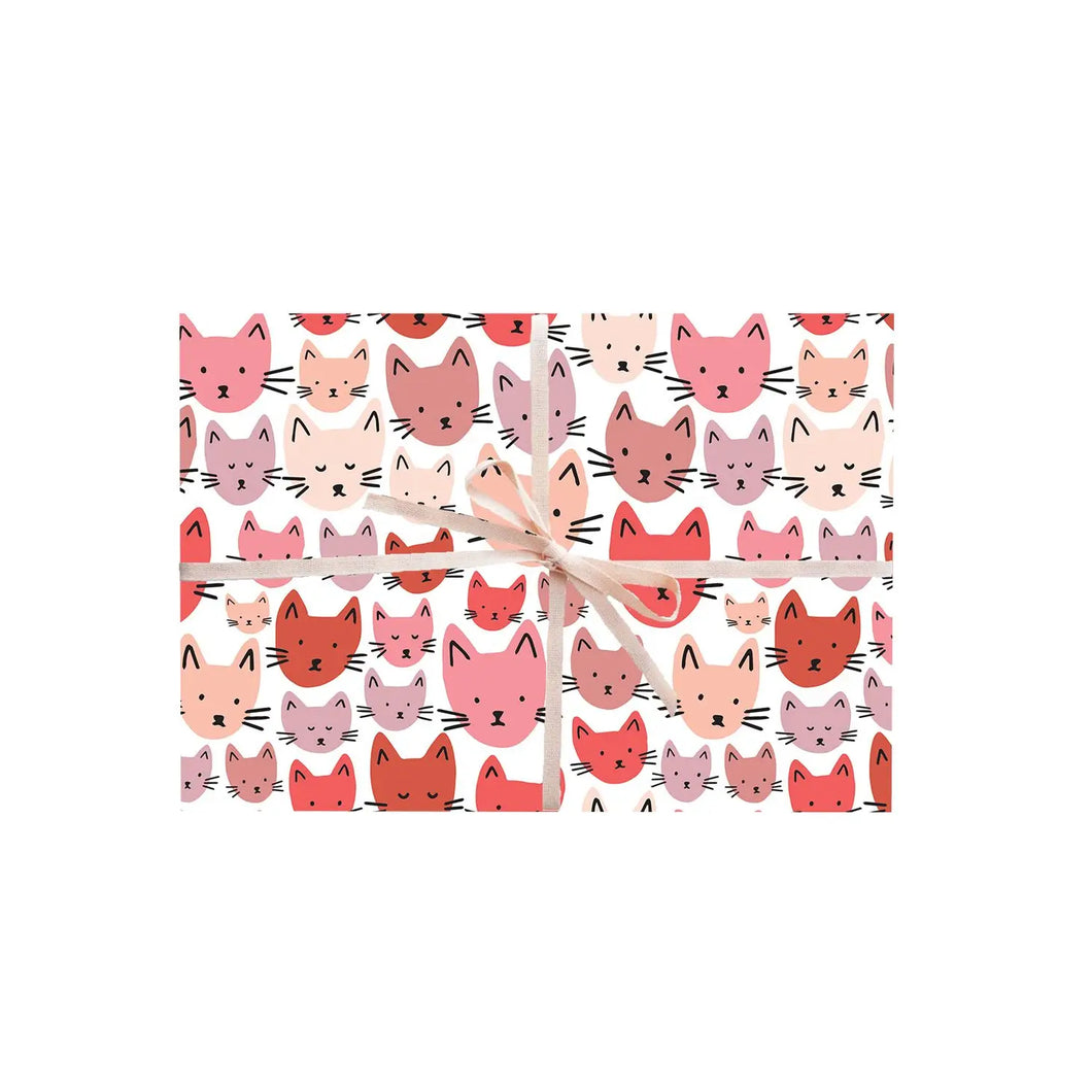 a single sheet of gift wrap featuring cute heads of cats in pink and red colours with black whiskers 