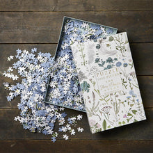 Load image into Gallery viewer, a danica floral jigsaw puzzle box open and loose pieces of puzzle on the table or surface
