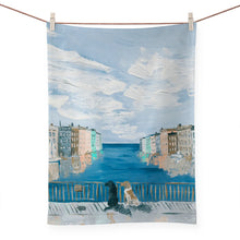 Load image into Gallery viewer, a colourful kitchen tea towel depicting 2 dogs sitting and gazing out on an ocean vista perhaps venice italy 
