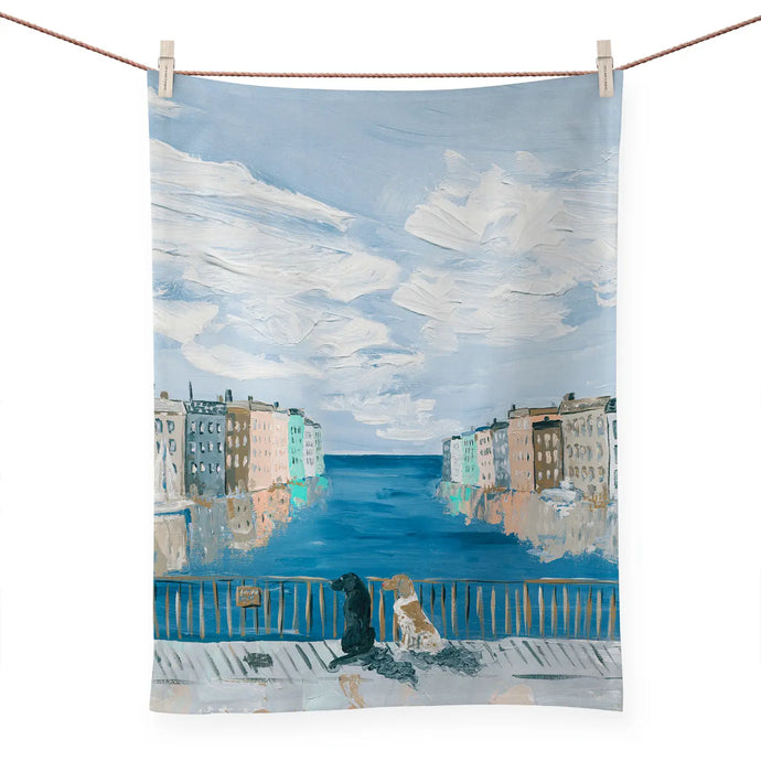 a colourful kitchen tea towel depicting 2 dogs sitting and gazing out on an ocean vista perhaps venice italy 