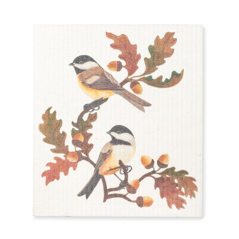 a Swedish dishcloth featuring 2 chickadee birds on an oak tree branch