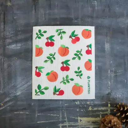 a kitchen dishcloth featuring fruit of peaches 
