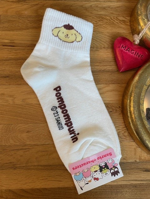 a pair of white coloured ankle socks with the sanrio pompompurin dog embroidered on the cuff