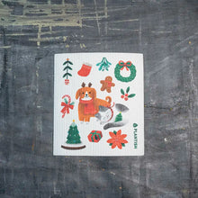 Load image into Gallery viewer, a kitchen dishcloth featuring holiday and Christmas characters 
