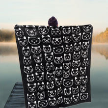 Load image into Gallery viewer, a person holding open a large blanket throw with white faced kitties on black side of reversible blanket 
