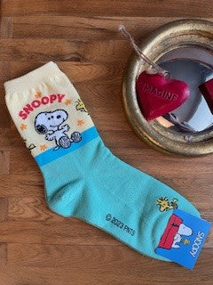 a pair of snoopy and woodstock socks from comic stip peanuts 