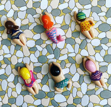 Load image into Gallery viewer, a photo of six little whimsical swimmers in different bathing suits on a mosaic background
