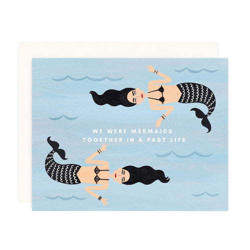 illustration of 2 mermaids on a blue backdrop