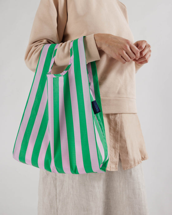 a baggu baby size  reusable bag in a awning stripe of green and ink 