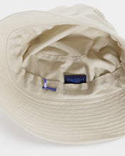 Load image into Gallery viewer, the interior of a baggu brown rice bucket hat showing the adjustable tab and label 
