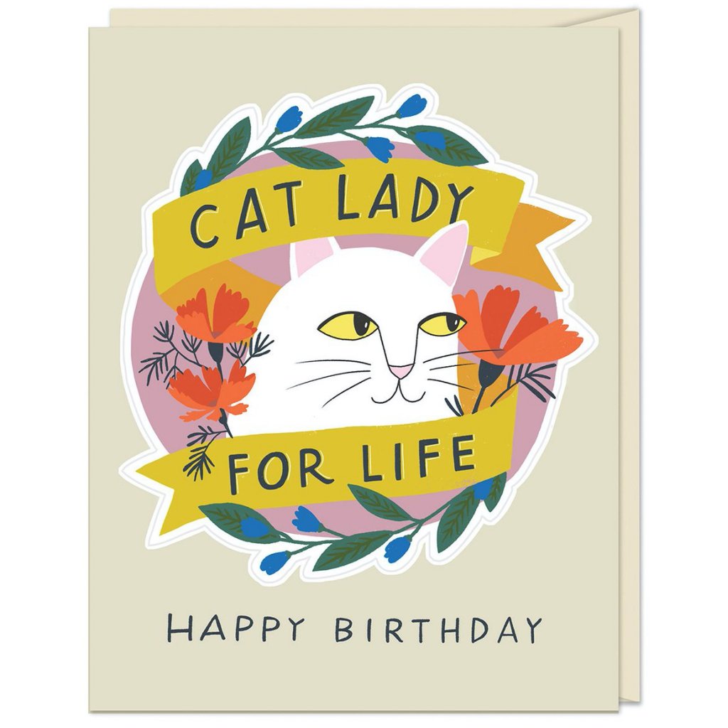 an illustration of a white cats face in a laurel with flowers around it says happy birthday at bottom on soft creme coloured background 
