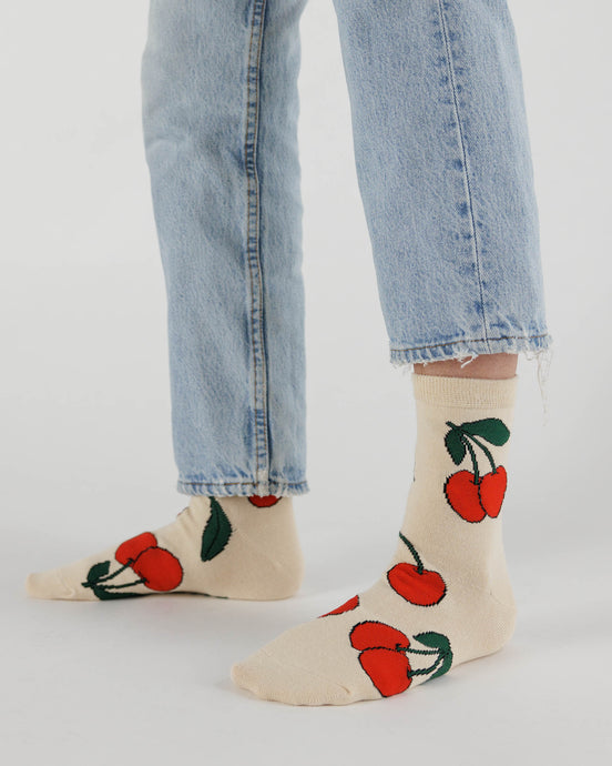 a person wearing the ecru cherry baggu bamboo socks 