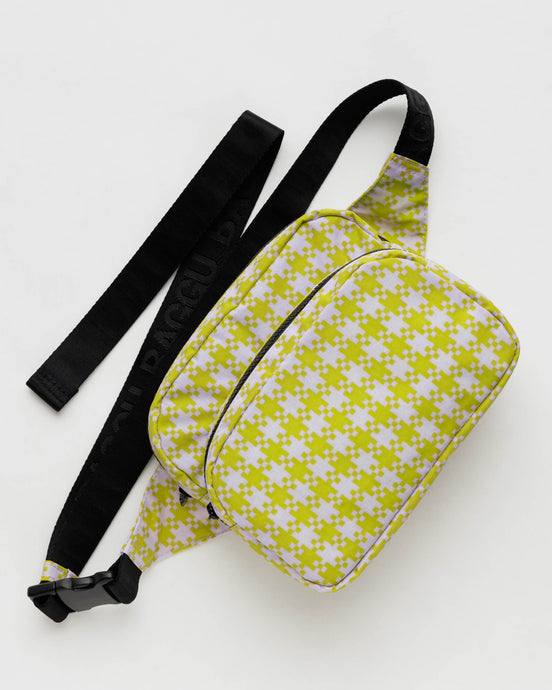 a baggu brand fanny pak in a yellow and light pink pixel gingham with black strap
