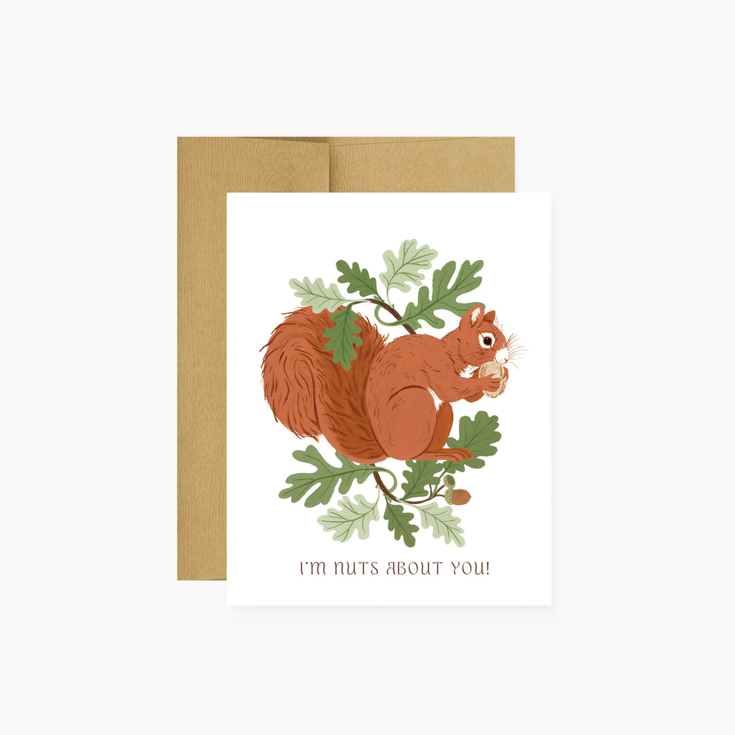 illustration of a squirell eating an acorn with green oak leaves all around on a white background .text I'm nuts about you