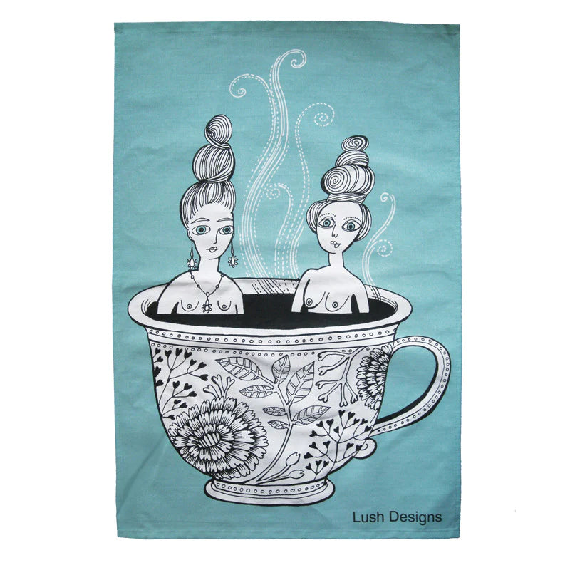 a tea towel with tow ladies sitting in a hot cup of tea 