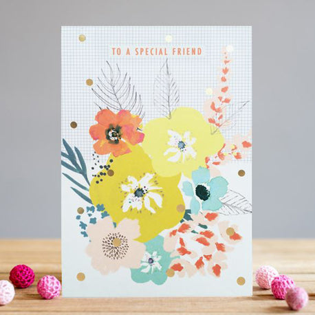 a white card covered in tiny black dots matrix with large yellow, blue, peach flower cluster script to a special friend in orange colour 