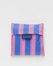 Load image into Gallery viewer, a blue and pink awning stripe baggu reusable tote case to hold the bag when not in use. 

