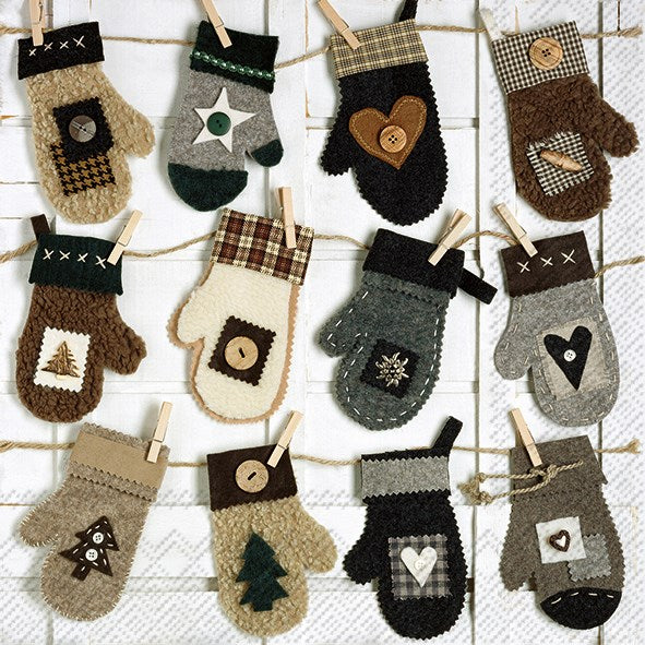 a package of luncheon sized paper napkins with cute felt homemade mittens on a string clipped with wooded pegs, very vintage 