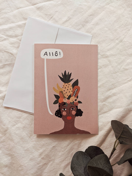 an illustration in colour of a dark skined woman wearing a hat made up of mixed fruits with a pinapple and papaya.with a cloud bubble over her head that says Allo . On a soft peach backdrop
