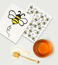 Load image into Gallery viewer, tow swedish dishcloths one with a large yellow and black bumble bee the over covered in smaller bumble bees pictured beside a bowl of honey and a honey dipper
