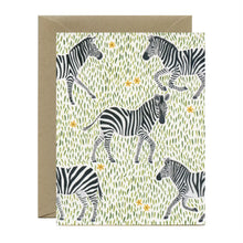 Load image into Gallery viewer, a greeting card with illustration of several zebras on little green blades of grass and leaves , no text
