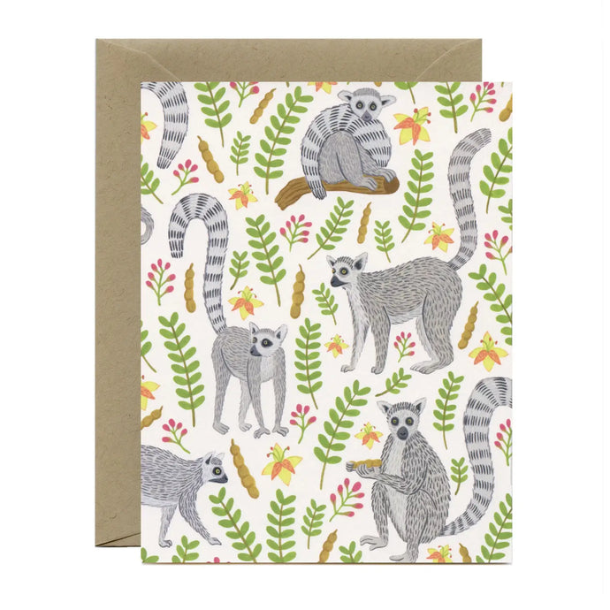 a greeting card with illustrations of lemurs and green leaves, no text