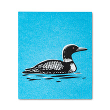 Load image into Gallery viewer, black and white loon bird on a blue backdrop as is swimming on the water
