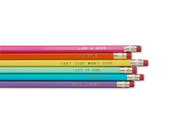 a set of six rainbow coloured ppencils with assorted boss words in gold text on each
