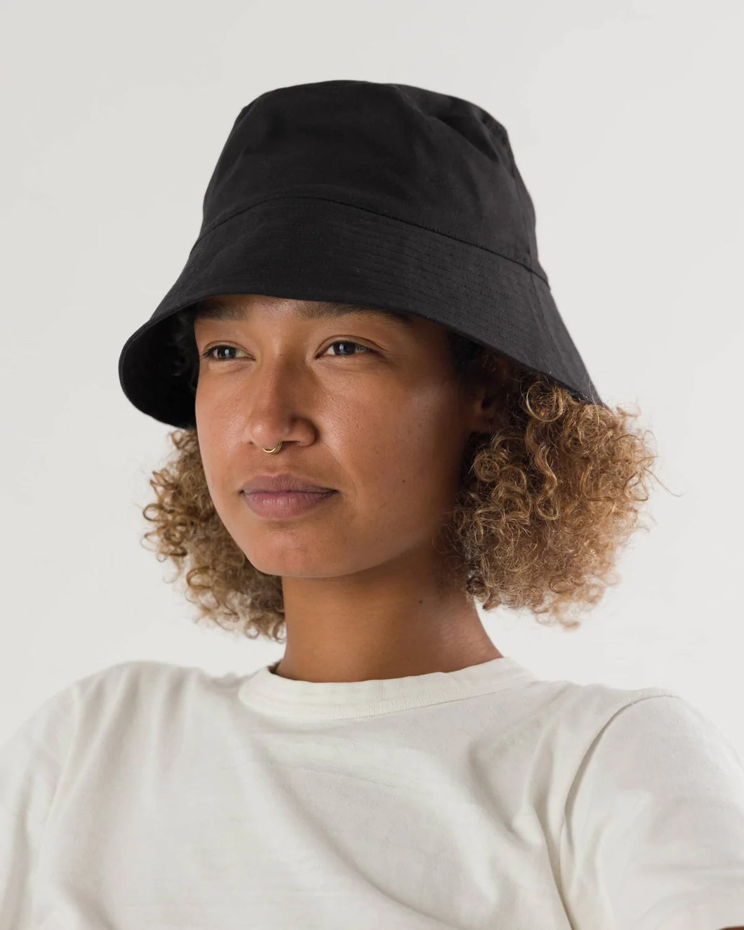 a person wearing a black baggu bucket hat 