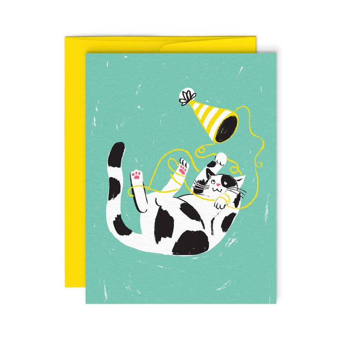 illustraion of a fun cat on its back playing with ribbon and a party hat 