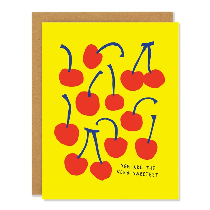 a bright yellow greeting card with several red cherries on front 