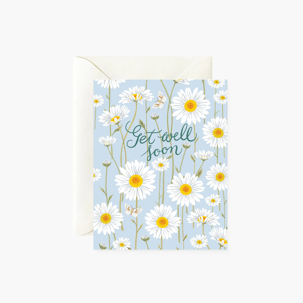illustration of white daisies with yellow centres on a soft blue greeting card